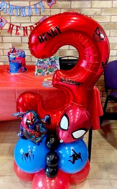 a spiderman themed birthday party with balloons