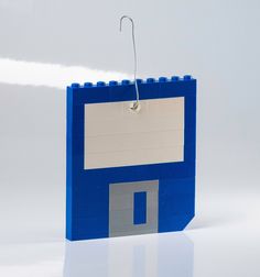 a blue lego building with a white tag attached to it's front end and bottom part