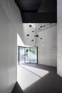 an empty room with concrete walls and flooring, as seen from the doorway to the outside