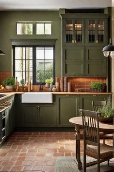 a kitchen filled with lots of green cupboards and counter top space next to a dining room table