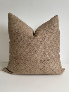 a brown pillow sitting on top of a white table