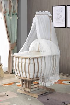 a baby crib with mosquito netting on the top and bottom, in a nursery room