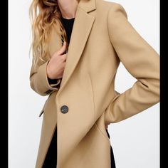 Coat Made Of Manteca High Quality Italian Wool Blend Fabric. Lapel Collar And Long Sleeves With Shoulder Pads. Flap Pockets At Front. Back Vent. Interior Lining. Front Button Closure. Best Seller Coat! Sold Out At Zara! Elegant Khaki Business Casual Outerwear, Elegant Khaki Outerwear For Business Casual, Elegant Khaki Long Pea Coat, Elegant Long Khaki Pea Coat, Beige Wool Coat With Double Button For Office, Khaki Winter Business Blazer, Tailored Beige Winter Outerwear, Winter Business Khaki Blazer, Formal Neutral Outerwear With Double Button Closure