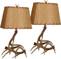 two lamps with antlers on them sitting side by side, one is brown and the other is beige