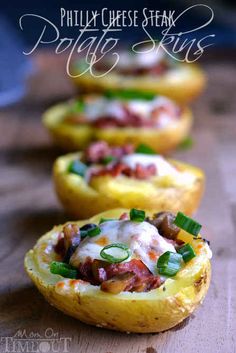 three baked potatoes with meat and vegetables on them sitting on a wooden counter top, ready to be eaten