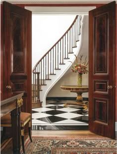 the front cover of an architectural magazine, featuring a staircase and marble table with chairs