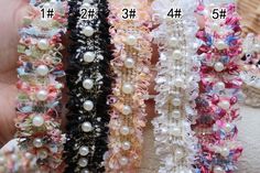 several different types of hair ties in various colors and sizes, with pearls on them