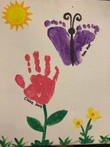 handprints and flowers are displayed on a piece of paper