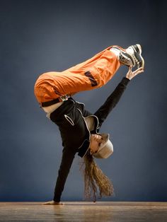 a woman is doing a handstand on the floor