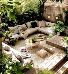 an outdoor living area with couches, tables and potted plants on the ground