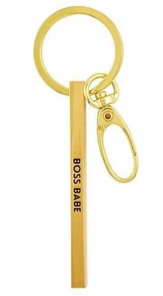 a gold keychain with the word bossie on it and a pair of scissors