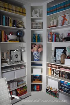 a white book shelf filled with lots of books