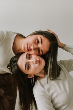 two women are posing for the camera with their arms around each other's shoulders