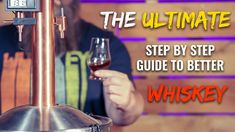 a man holding a glass of wine in front of a machine with the words, the ultimate step by step guide to better whiskey