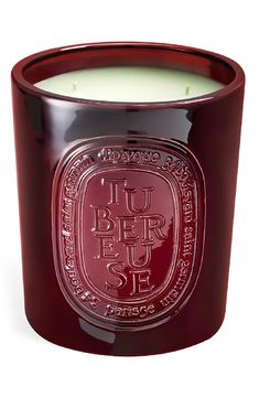 a red glass candle with the words luber fuse on it's side