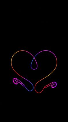 a neon heart with headphones in the shape of a heart on a black background