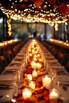 A long table adorned with fall candles, autumn leaves, and string lights creates an intimate setting for a stunning wedding in autumn. Fall Wedding Tables. November Wedding Indoor, Fall Wedding Memory Table, Cabin Theme Wedding, October Wedding Ceremony Decor, Small October Wedding, Wedding Theme Sunflowers, Fall Wedding Bright Colors, Autumn Wedding Table Settings, Fall Wedding Mountains