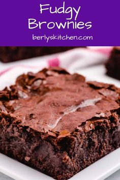 chocolate fudge brownies on a white plate with text overlay that reads fudge brownies