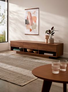 a living room scene with focus on the coffee table and vases in the foreground