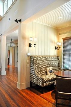 a living room with hard wood floors and white walls