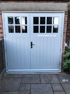 an image of a white garage door with glass inserts on the sides and side windows