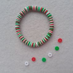 Handmade Christmas coloured clay bead bracelet in red, green and white - perfect as a stocking filler or gift for a teenage girl. Elasticated and will fit a wrist size of approximately 16cm. I use good quality elastic so my bracelets are stretchy and durable. The knots are tied in a professional way to be as small and safe as possible.  CARE - not suitable for children under 3 years.     Your bracelet will be wrapped in tissue paper, tied up and fastened with an EmysPrettyBracelets tag. Please a Clay Beads Christmas Ideas, Clay Bead Bracelet Ideas Christmas, Xmas Bracelets, Winter Bracelets, Winter Jewellery, Winter Bracelet, Winter Board