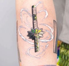 a cross tattoo on the right arm and shoulder with an arrow in the center, surrounded by flowers