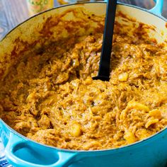 a blue pot filled with food on top of a wooden table