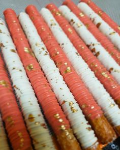 several carrots with gold sprinkles are lined up on a table top