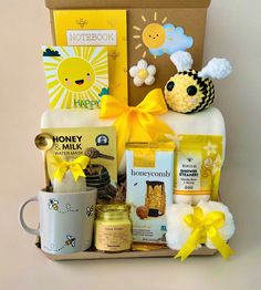 a gift box filled with honey, cookies and other items for someone's special occasion