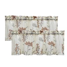 two curtains with floral designs on them