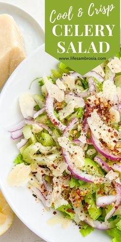 a white plate topped with a salad covered in cheese