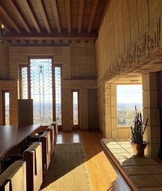 an empty room with wooden tables and chairs