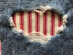 an old pair of jeans that has been torn in half with red and white stripes