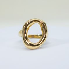 add a touch of elegance and confidence to your ensemble with our Saturday Sun Ring. this statement ring features a unique, open design that will elevate any look. perfect for those seeking to make a stylish and sophisticated statement. 18k gold pvd over 316L stainless steel water resistant top of ring is 18 x 22mm band is 3mm thick Chic Open Ring Jewelry With Polished Finish, Trendy Gold Rings With Polished Finish, Trendy Polished Gold Rings, Chic Yellow Gold Ring With Polished Finish, Modern Open Band Rings Tarnish Resistant, Chic Gold Ring With Polished Finish, Modern Open Band Tarnish Resistant Rings, Elegant Formal Dome Ring In Metal, Modern Yellow Gold Rings