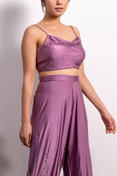 Purple crop top with cowl neckline and shoulder straps. Comes with high waisted embroidered pants.
Component: 2
Pattern: Embroidery
Type Of Work: Pearl, Sequin and Cutdana
Neckline: Cowl Neck
Sleeve Type: Sleeveless
Fabric: Lycra
Color: Purple
Other Details: 
Pants with embroidery on the hem
Shoulder straps
Closure: Side zip
Note: Blouse padded only up till size: 2XL
Occasion: Party - Aza Fashions Cowl Neck Crop Top, Crop Top And Pants Set, Purple Crop Top, Embroidered Pants, Purple Pearl, Top And Pants Set, Pattern Embroidery, Cowl Neckline, Neck Crop Top