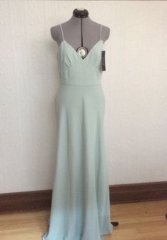 This dress has been bought and never worn. It is therefore new with tags. Would be perfect for a special event. It is a size 10. I believe a regular size 10 or even a size 12 could fit into it. Adjustments might have to be made. It will have to be hemmed as it is very, very long. It must be taken in to a seamstress to fit perfectly. Please ask all questions before buying. Thank you ! Bridesmaid Wedding, Favorite Sweater, Liberty Fabric, Pale Green, White Blouse, Wedding Bridesmaids, Dress Clothes For Women, Special Event, Wedding Guest