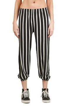 A bold take on an iconic '80s style, these laid-back pants show off contrasting stripes and relaxed balloon legs in a cropped silhouette. 21" inseam; 7 1/2" leg opening; 10 1/2" front rise; 14 1/2" back rise (size S) 100% polyester Dry clean Made in the USA Retro Black Bottoms For Spring, Baggy Striped Bottoms For Spring, Black Pants With Elastic Cuffs For Spring, Summer Bottoms With Vertical Stripes And Tapered Leg, Spring Pants With Contrast Stripes, Black Bottoms With Striped Hem For Spring, Black Spring Bottoms With Striped Hem, Trendy Bottoms With Contrast Stripes For Spring, Black Pants With Contrast Stripes For Spring