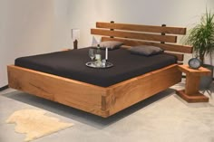 a bed that is made up with wooden slats and pillows on top of it