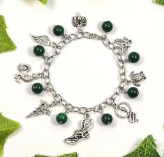 a green bracelet with charms and leaves