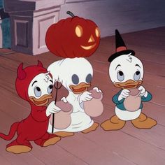 three cartoon characters dressed in halloween costumes