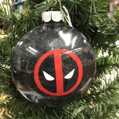 a deadpool ornament hanging on a christmas tree in the shape of a ball