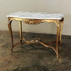 a marble topped table with gold trimming