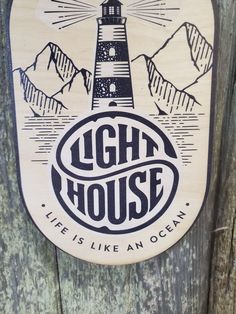 a wooden sign that says light house life is like an ocean with a lighthouse on it