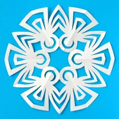 paper cut out of white shapes on a blue background