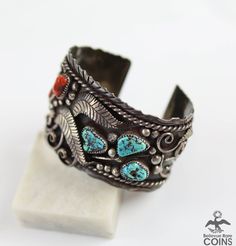 Embrace the essence of the Southwest with our Vintage Native Silver Turquoise & Red Coral Wide Boho Cuff Bracelet. This stunning piece features a beautifully detailed Southwestern motif, crafted with premium silver and adorned with striking turquoise and red coral stones. Elevate your style with this unique and luxurious bracelet. * Weight: 88.6 grams * Measurements: 1.9" width, 2.5" inside width, 1" gap Southwestern Adjustable Multi-stone Cuff Bracelet, Luxurious Bracelet, Turquoise Silver Bracelet, Boho Cuff Bracelet, Boho Cuff, Gold Bullion, Coral Stone, Bracelet Vintage, Fine Jewelry Bracelets