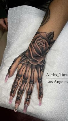 a woman's arm with a rose on it and the words alexs tarz los angeles