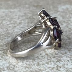 Garnet Cluster Ring Sz 7/Sterling Silver/Genuine 5.4ct Marquise Cut/Rhodolite Garnet/Signed/Pink Purple Garnet/Vintage Estate/Ring For Women Description Beautiful rhodolite garnet ring in excellent vintage condition. A total of 5.4ct of genuine, marquise cut garnet set in designer signed stamped 925 sterling silver setting. Face of ring measures 20mm from top to bottom and has a weight of 5.1g. Gorgeous pink purple color and fantastic sparkle! Size 7. All Gems tested with Presidium Gem Tester. A Classic Silver Multi-stone Gemstones, Collectible Garnet Gemstone Ring, Formal Marquise Ruby Ring With Accent Stones, Classic Silver Amethyst Ring With Multi-stone, Garnet Multi-stone Anniversary Rings, Silver Marquise Ruby Ring For Anniversary, Formal Garnet Gemstone Cluster Ring, Multi-stone Garnet Rings For Anniversary, Formal Multi-stone Marquise Ruby Ring