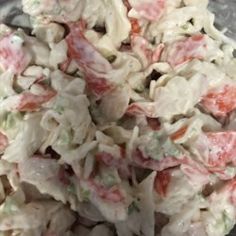 a pile of food that is sitting on top of a glass plate with some kind of meat in it