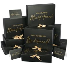 six black boxes with gold foil lettering and bows on the top one says, will you be my bridesmaid?